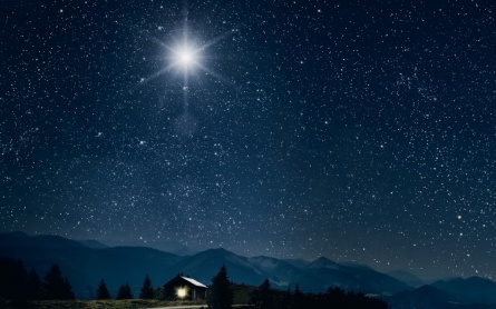 The star shines over the manger of christmas of Jesus Christ.